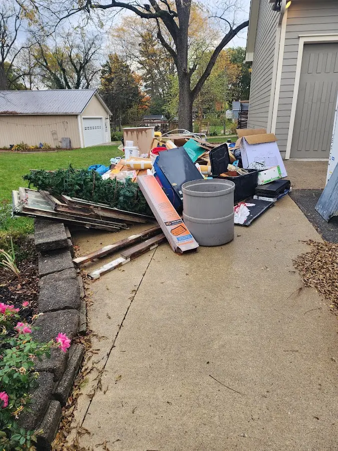Dumpster being loaded with debris for Estate Cleanout Dumpster Rental in Lake Arbor